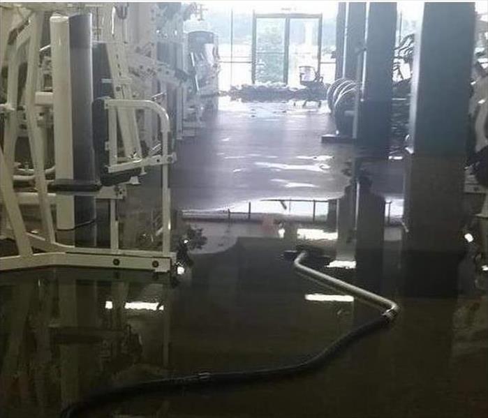 sandbags at front entrance, flooded fitness center floor 
