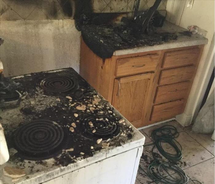 charred range and countertop (sink) walls and appliances