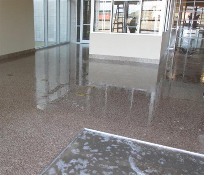 soapy water still on the floor cleaning in this lobby