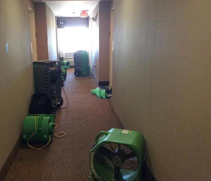 equipment drying a carpet in the hotel hallway